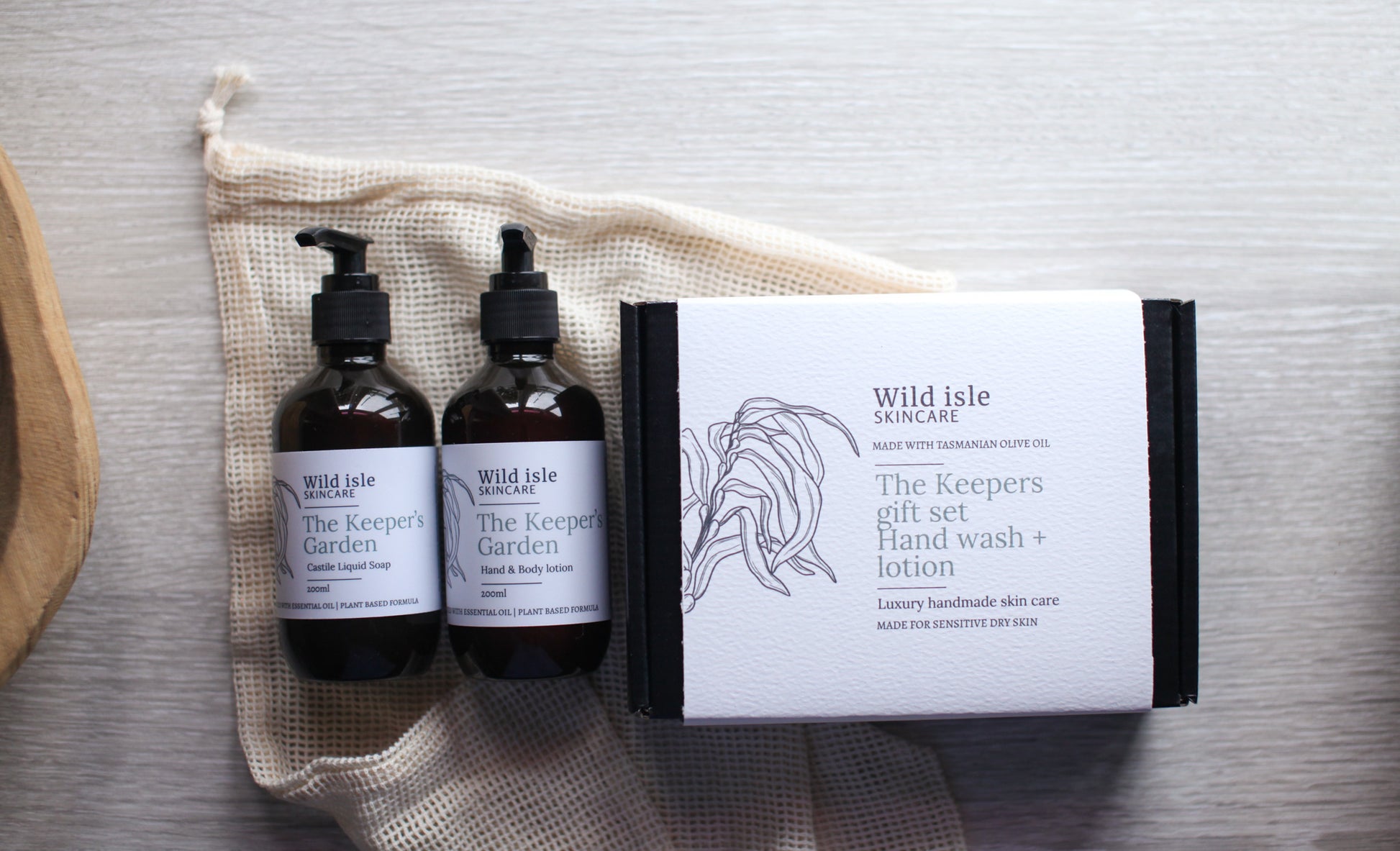Wild Isle Organics gift set with two bottles and a liquid castile soap on a textured surface.