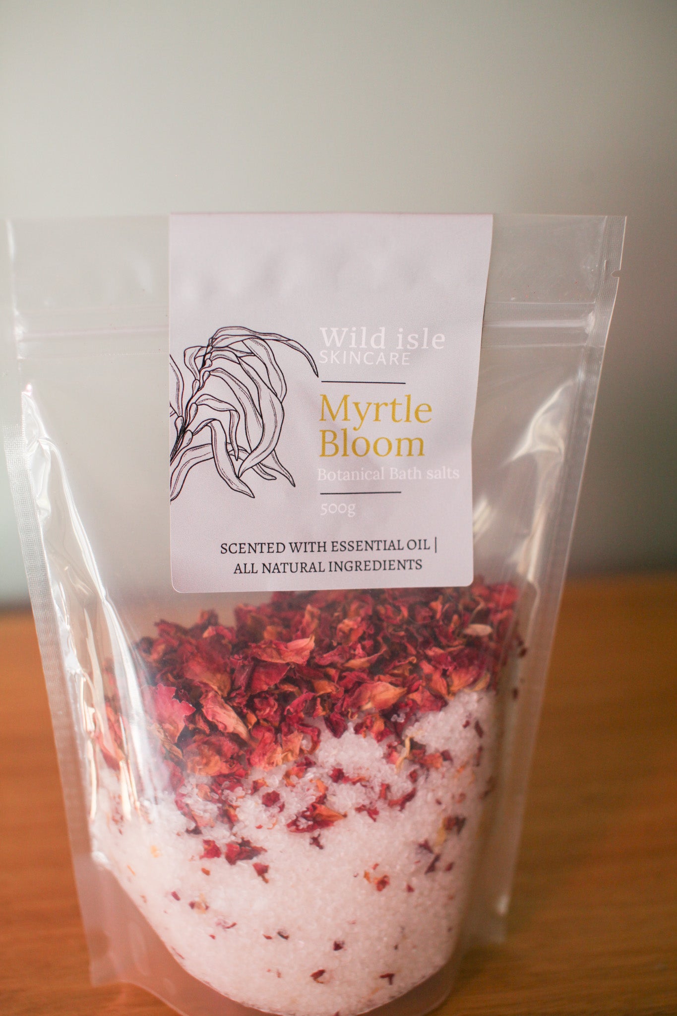 Packaged product labeled 'Myrtle Bloom' with a visible label on a wooden surface.